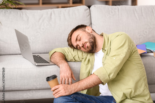 Tired male student sleeping...