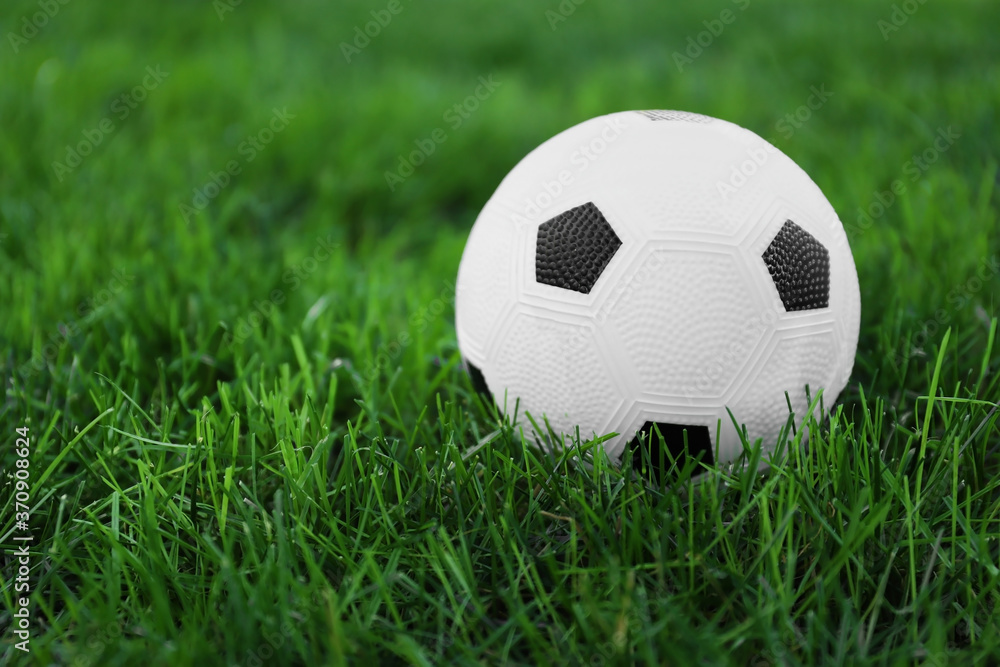 Soccer ball on green grass outdoors Soccer ball on green grass outdoors