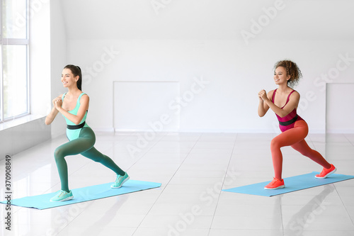 Young women doing aerobics in gym