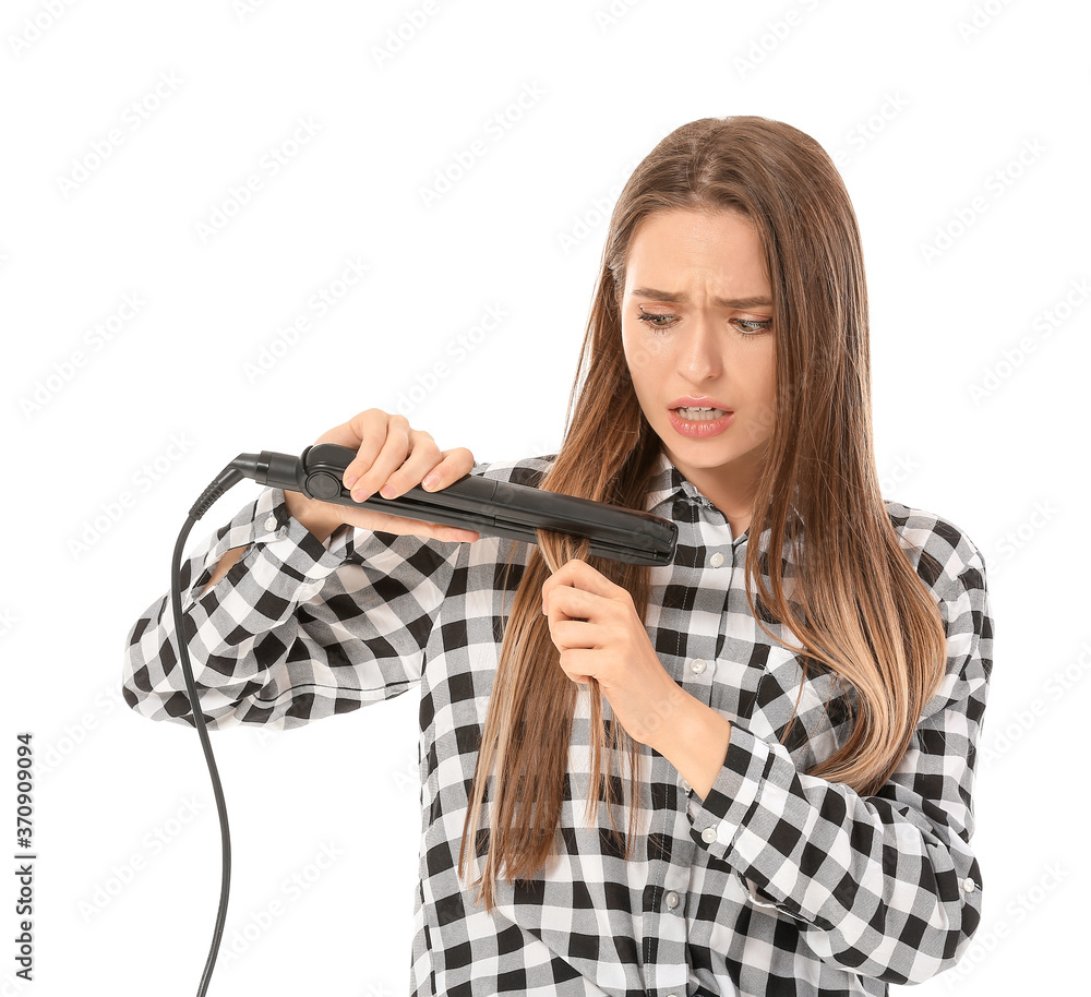 Stressed woman with straightening iron on white background Stressed woman with straightening iron on white background
