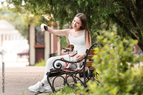 Young woman with cute dog t...