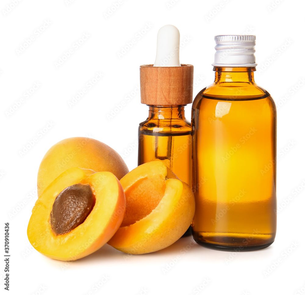 Bottles of apricot essential oil on white background Bottles of apricot essential oil on white background