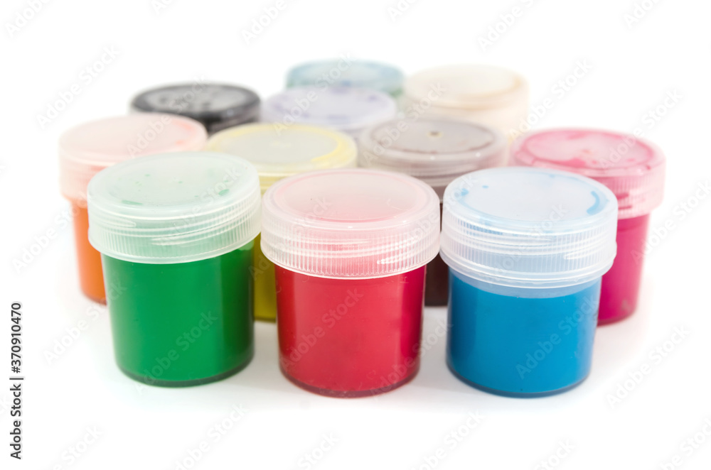 Several cans of gouache in different colors isolated on a white background. Several cans of gouache in different colors isolated on a white background.