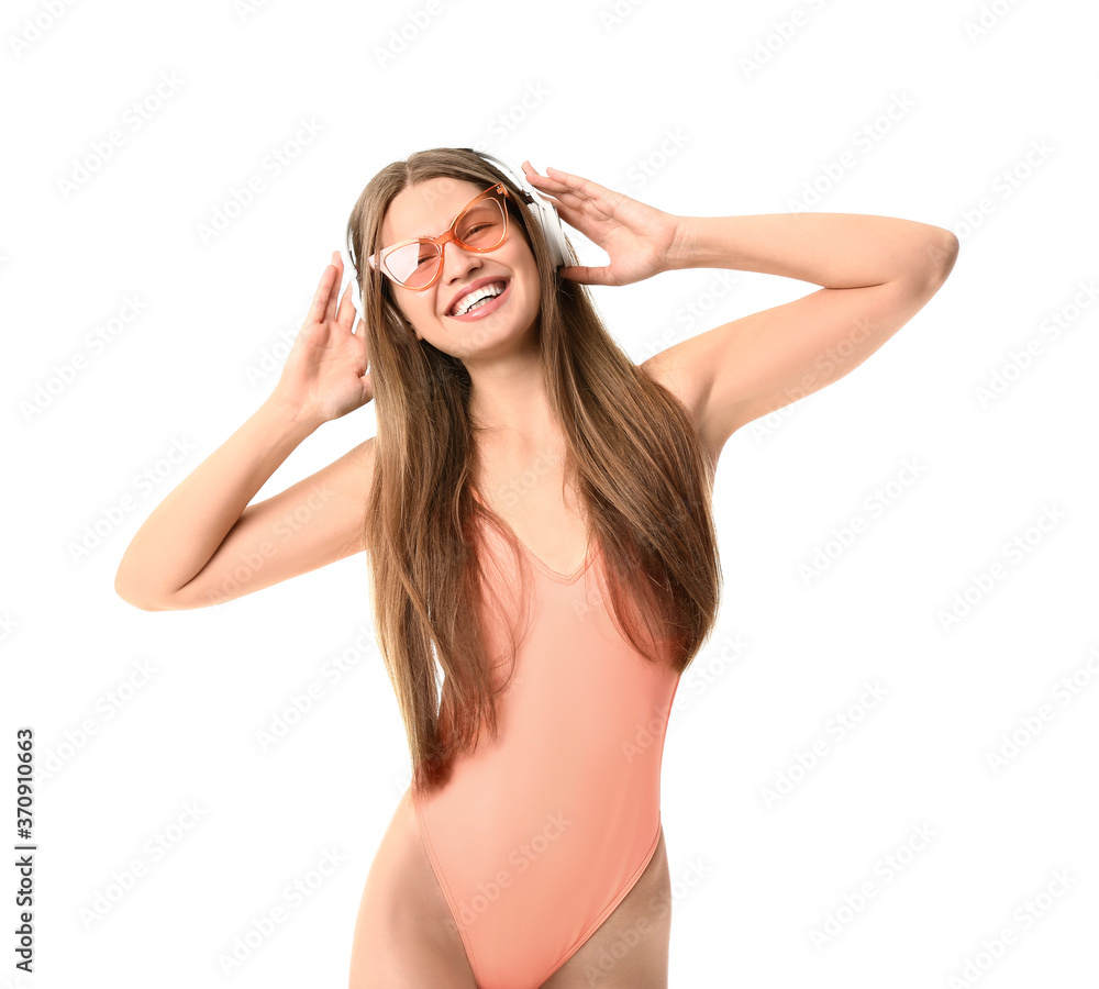 Young woman with headphones on white background