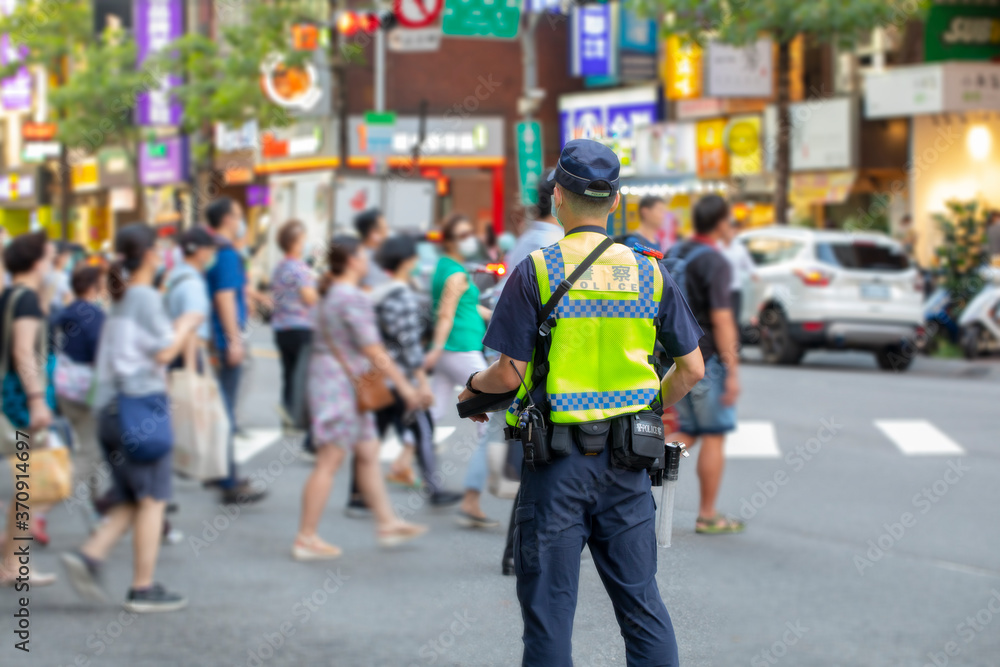 The police patrolling at the crossroads to guard the safety of the people