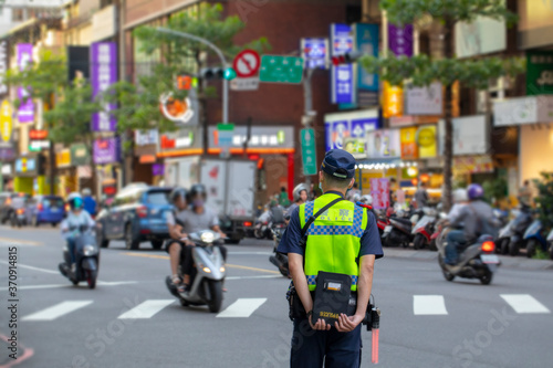 The police patrolling at the crossroads to guard the safety of the people