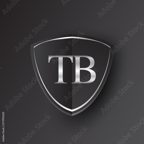 Initial logo letter TB with shield Icon silver color isolated on black background, logotype design for company identity.