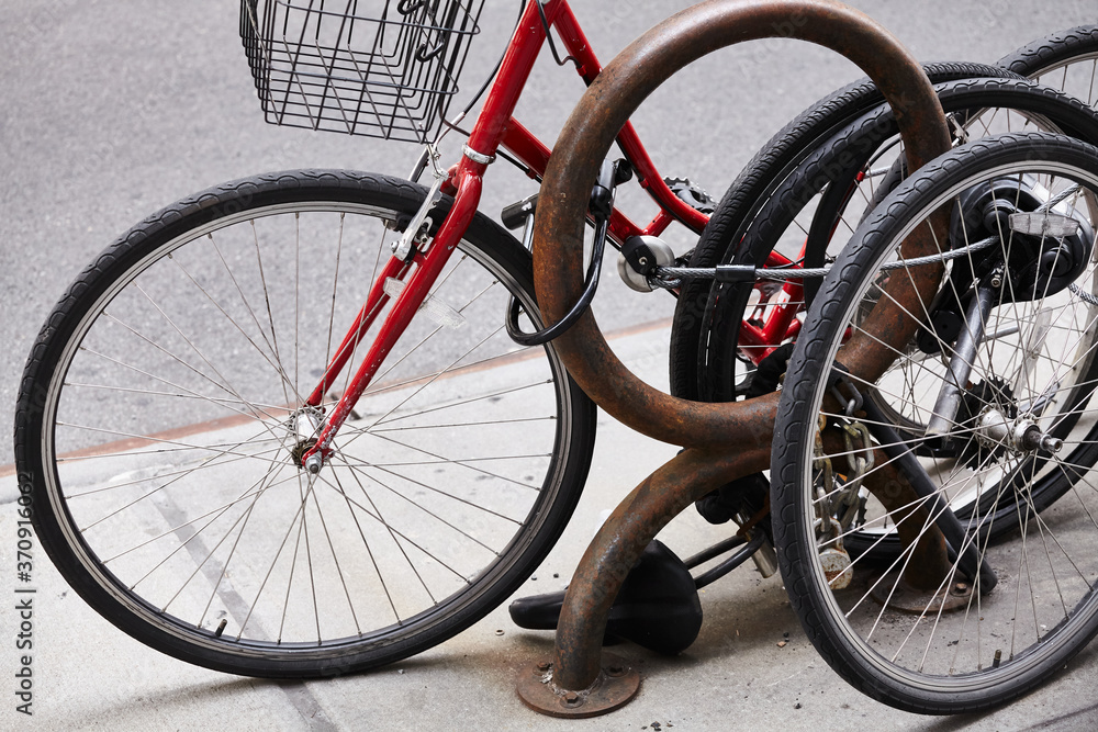 Close up picture of locked bicycle wheels, New York City, USA. Close up picture of locked bicycle wheels, New York City, USA.