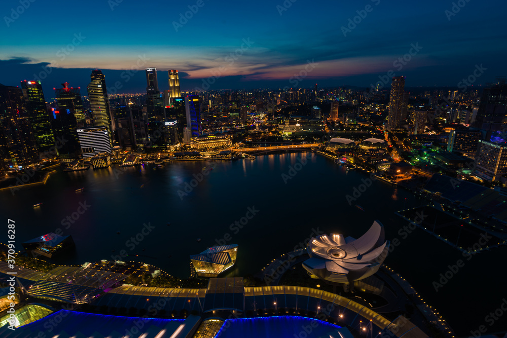 Sunset Singapore Marina Bay rooftop view with urban skyscrapers at night