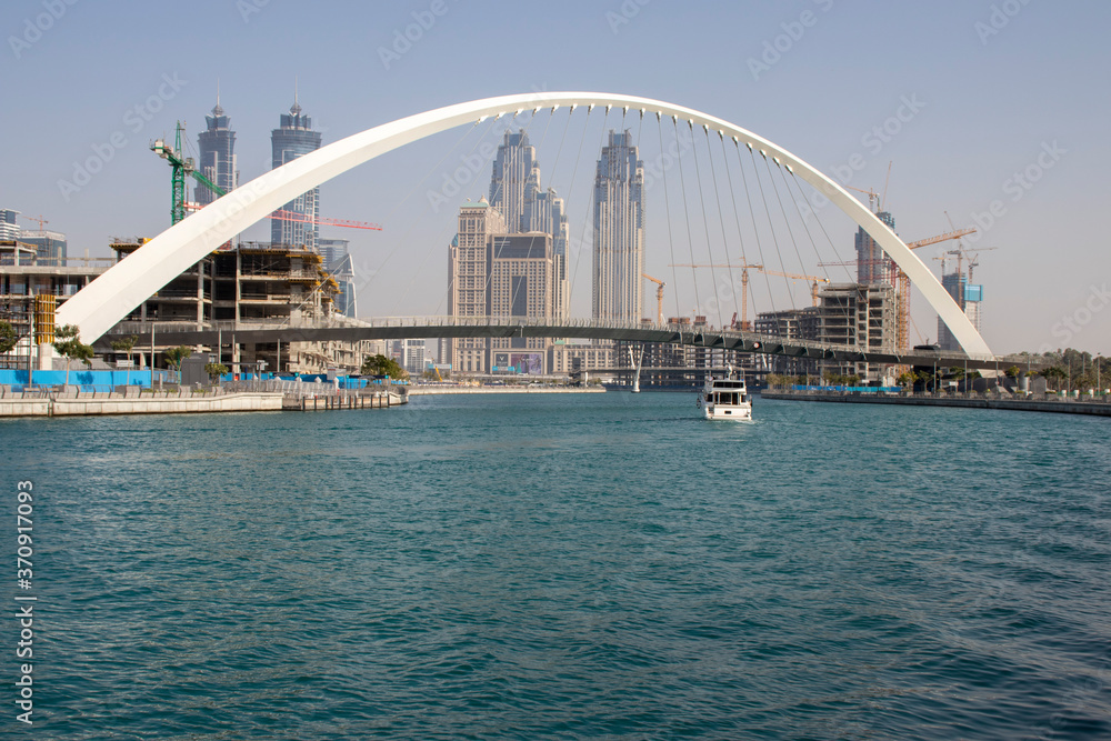 View of a business bay district and Tolerance bridge in Dubai, United Arab Emirates. Day time