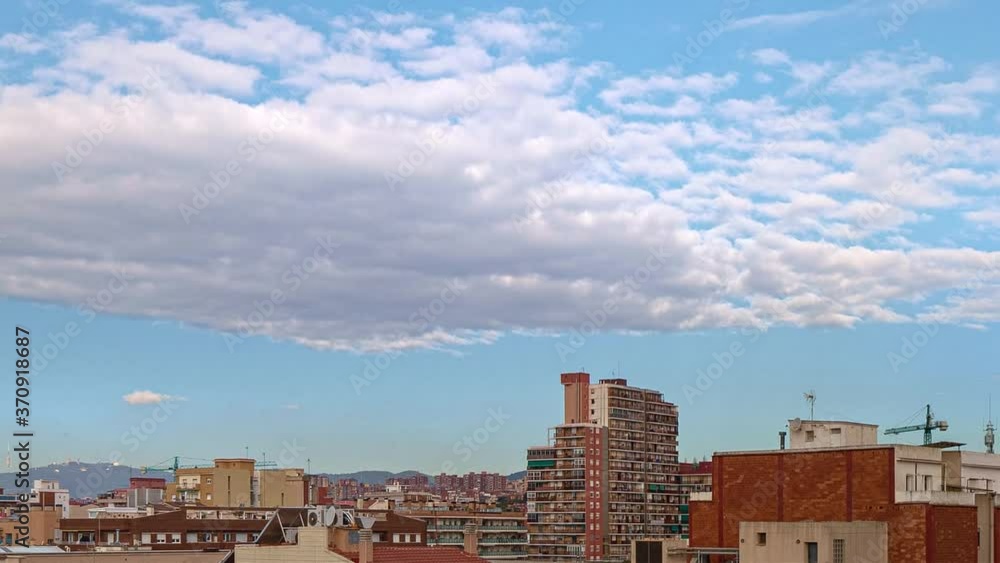 Timelapse zoom out of panoramic view from Badalona to Barcelona, rooftops and clouds passing by on summer day. Spain Timelapse zoom out of panoramic view from Badalona to Barcelona, rooftops and clouds passing by on summer day. Spain