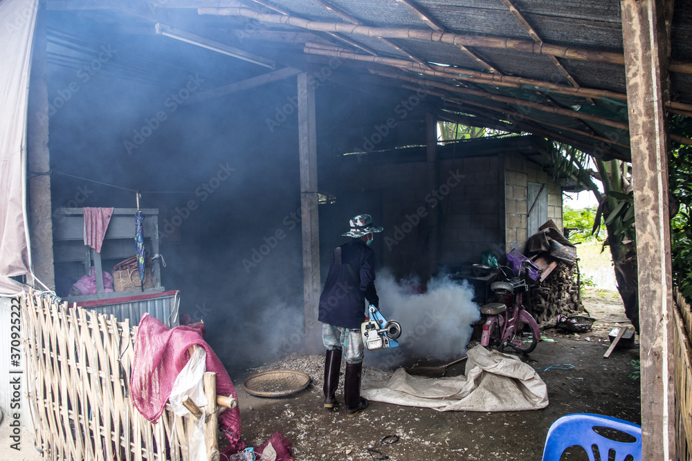 Fototapeta premium Officers enter the area to spray fog to prevent dengue fever.