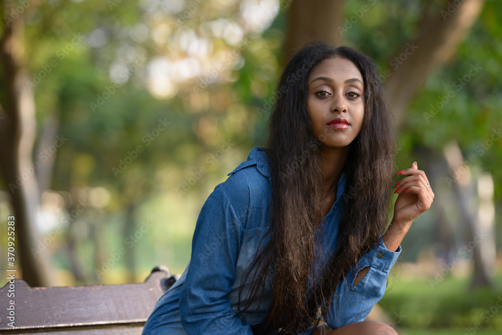 Portrait of young beautiful African woman at the park outdoors Portrait of young beautiful African woman at the park outdoors