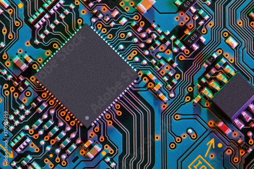 Electronic circuit board with electronic components such as chips close up. Blurry background.	 photo