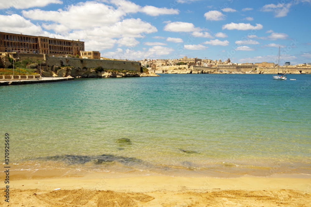 View of Valletta from a sandy beach in Kalkara, Malta