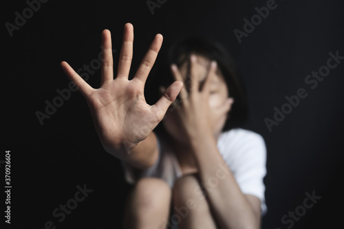 Stop violence and abused children.child showing stop hand on black background.