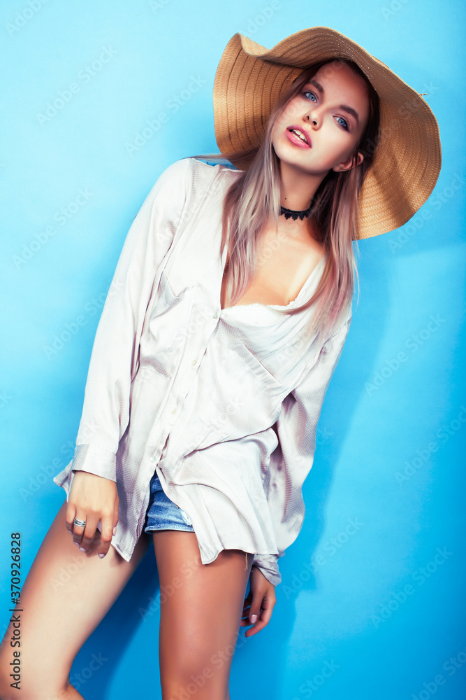 young pretty girl in big hat posing happy smiling on blue background, lifestyle people on summer vacation concept young pretty girl in big hat posing happy smiling on blue background, lifestyle people on summer vacation concept