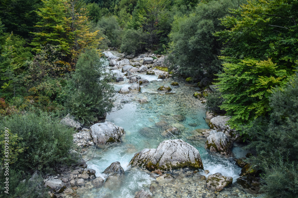 scenic mountainous landscape with stony river with clear blue waters in Valbone nature park