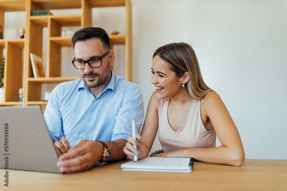 Close-up image of two business people working together. Close-up image of two business people working together.
