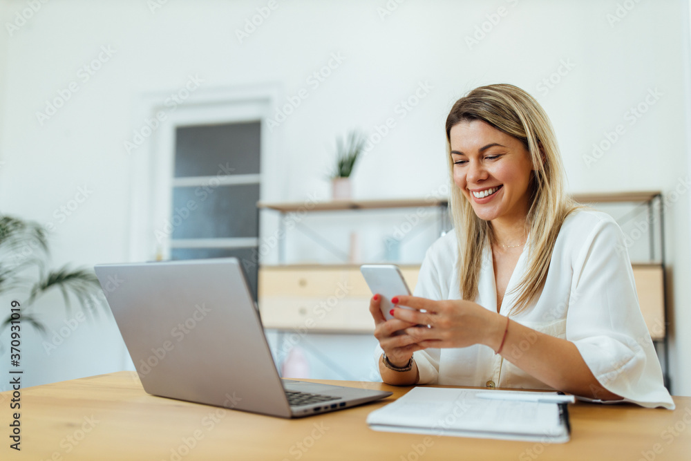 Portrait of a happy woman using smart phone.
