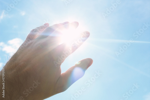 Hand covering the bright sun. Background. Texture. photo