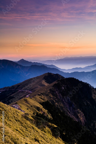 Layers of magnificent mountains at sunset with colorful clouds background. Hehuan Mountain in Taiwan  Asia. Taiwan Central Mountain Range.