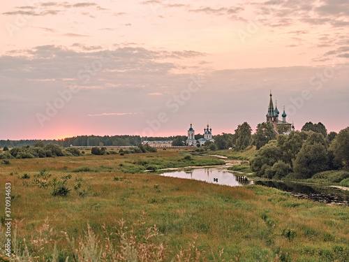 church by the river. summer landscape in the village