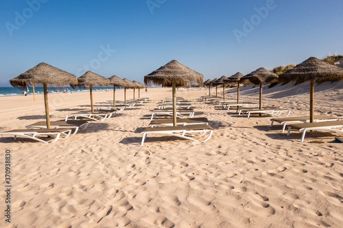 Parasols and hammocks on La Barrosa beach in Sancti Petri, Cadiz, Spain
