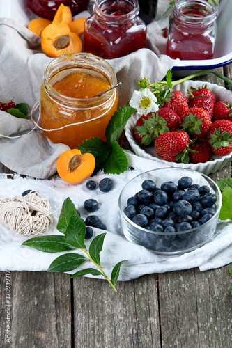 Assortment of jams and seasonal berries, fruits