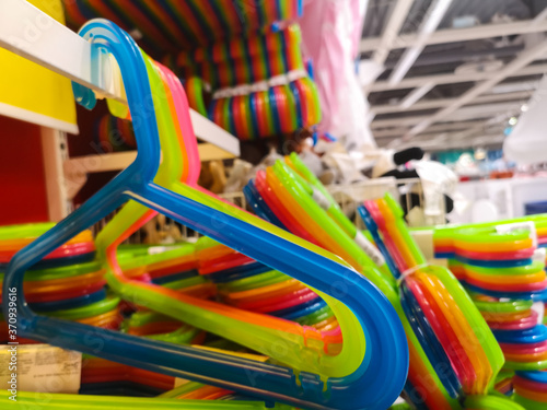 a set of plastic multicolored hangers for sale in a shopping center