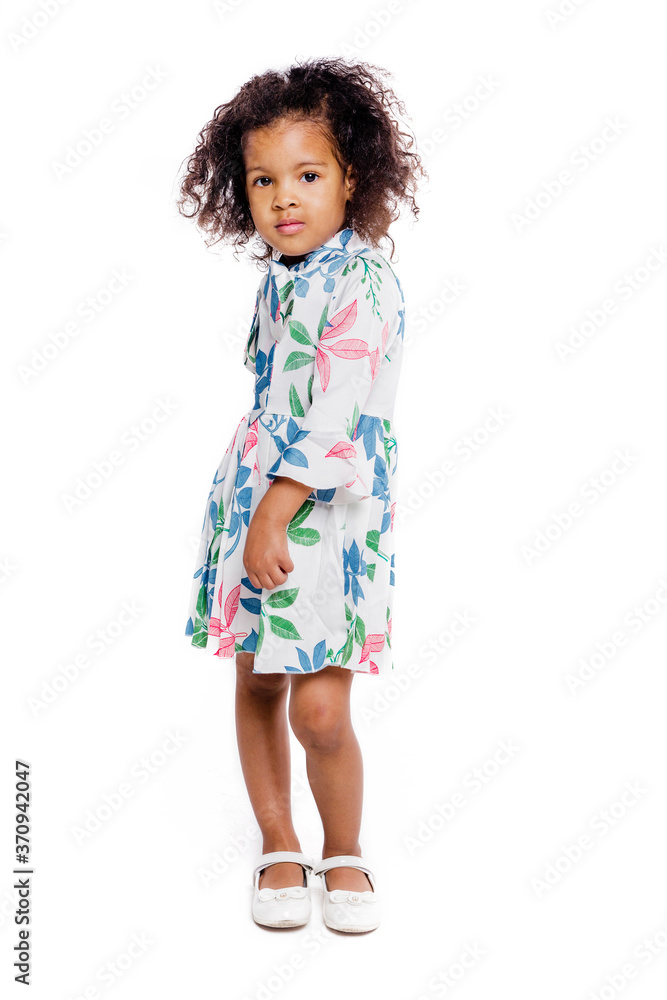 Portrait of pretty little african american girl in white floral dress on white background Portrait of pretty little african american girl in white floral dress on white background