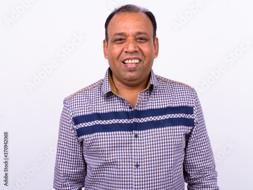 Portrait of happy mature overweight Indian businessman