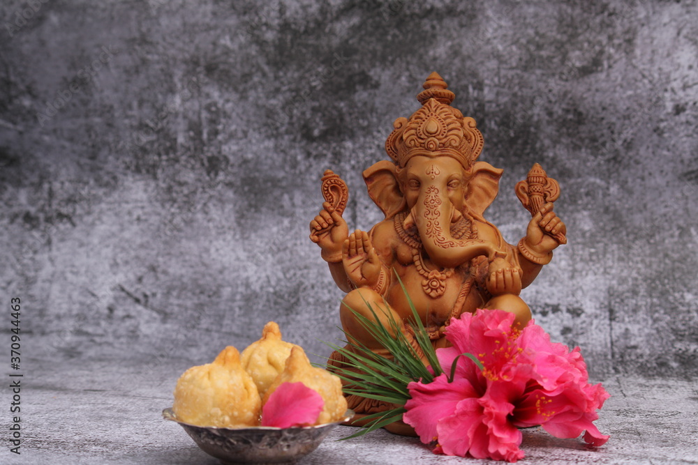 Ganesh Puja - Sweet Modak food offered on Ganpati festival or Chaturthi in India. served in silver bowl on white background. Ganesh Puja - Sweet Modak food offered on Ganpati festival or Chaturthi in India. served in silver bowl on white background.
