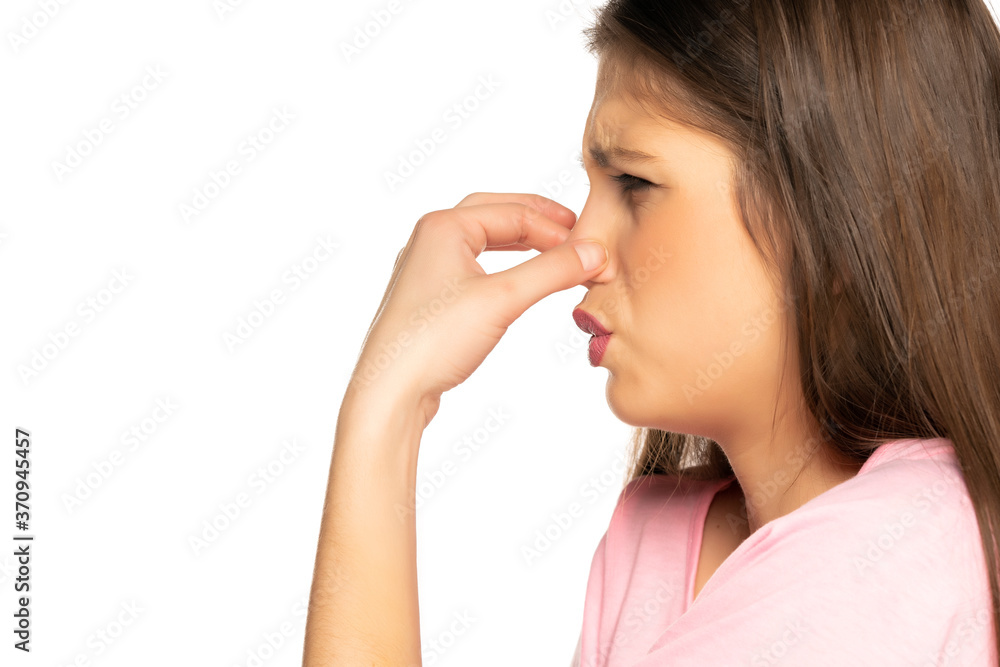 Young disgusted woman pinching her nose Young disgusted woman pinching her nose
