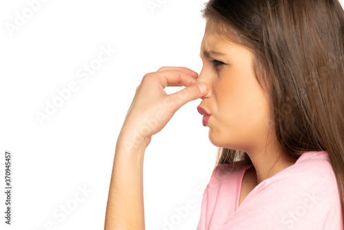 Young disgusted woman pinching her nose