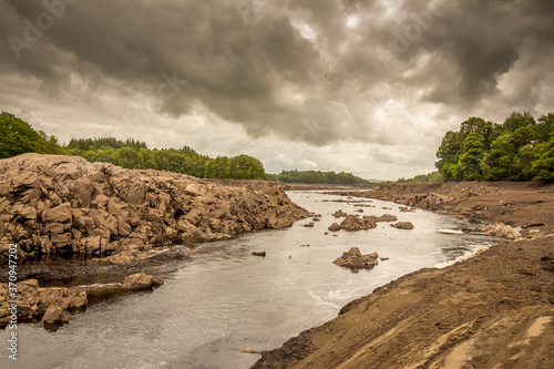The Water of Ken river in the drained or dewatered Earlstoun Dam and Loch