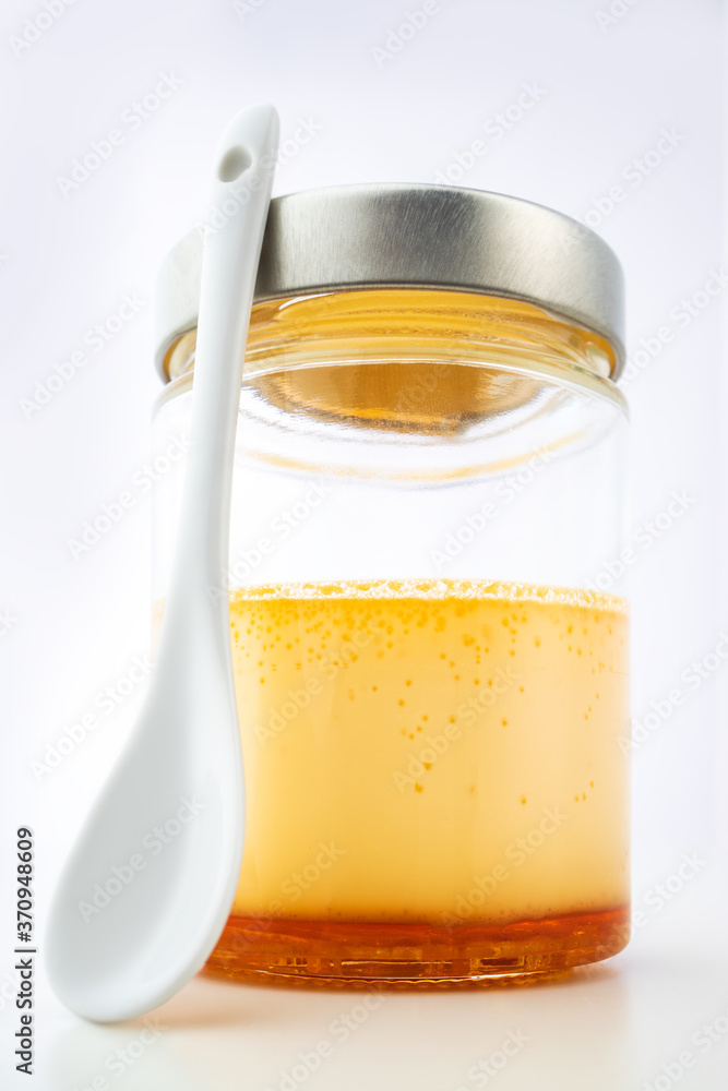 Cream caramel in a jar isolated on white background