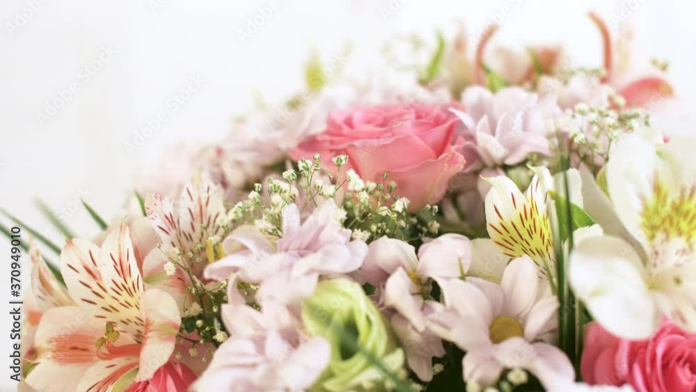 Beautiful large bouquet of different flowers rotating on a white background. Close up of differents colored summer and spring flowers. 4k background footage. Beautiful large bouquet of different flowers rotating on a white background. Close up of differents colored summer and spring flowers. 4k background footage.