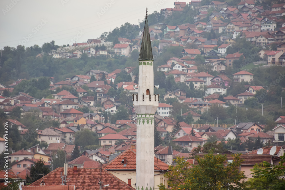 Muslim mosque minaret with Sarajevo hills in the background