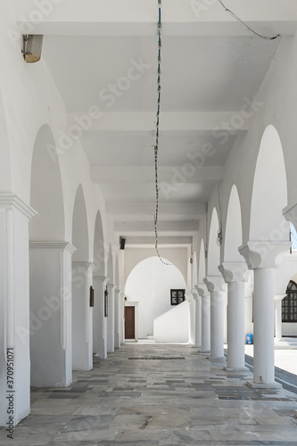 Open white gallery of Orthodox Cathedral (the Metropolis of Naxos) in Chora of Naxos island, Greece photo