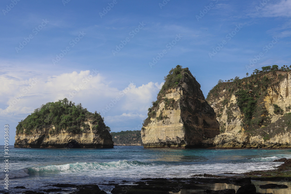 The beautiful Diamond Beach on Nusa Penida Island, Bali, Indonesia. Amazing view, white sand beach with rocky mountains and azure lagoon with clear water of Indian Ocean The beautiful Diamond Beach on Nusa Penida Island, Bali, Indonesia. Amazing view, white sand beach with rocky mountains and azure lagoon with clear water of Indian Ocean