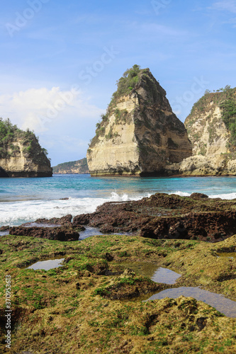 The beautiful Diamond Beach on Nusa Penida Island, Bali, Indonesia. Amazing view, white sand beach with rocky mountains and azure lagoon with clear water of Indian Ocean 