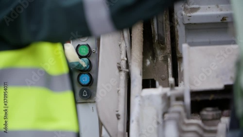 Close up of garbage truck picking up a city trash bin. Collecting waste. Stop pollution