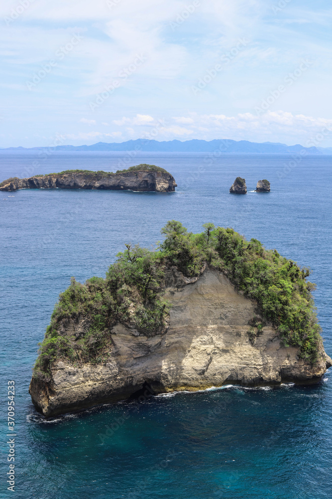 The beautiful Diamond Beach on Nusa Penida Island, Bali, Indonesia. Amazing view, white sand beach with rocky mountains and azure lagoon with clear water of Indian Ocean The beautiful Diamond Beach on Nusa Penida Island, Bali, Indonesia. Amazing view, white sand beach with rocky mountains and azure lagoon with clear water of Indian Ocean