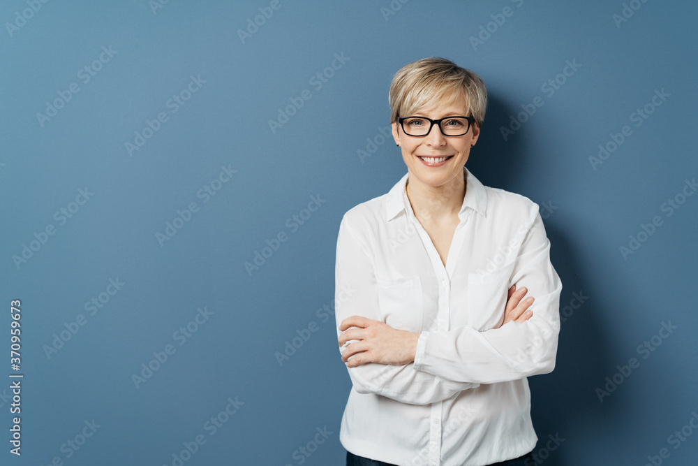 Smiling woman in white blouse with crossed arms Smiling woman in white blouse with crossed arms