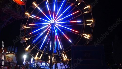 Traveling Fairground Ferris Wheel At Night With Bright Flashing Lights Ontario Canada photo