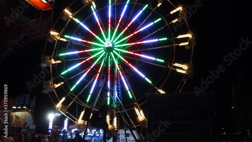 Traveling Fairground Ferris Wheel At Night With Bright Flashing Lights Ontario Canada photo