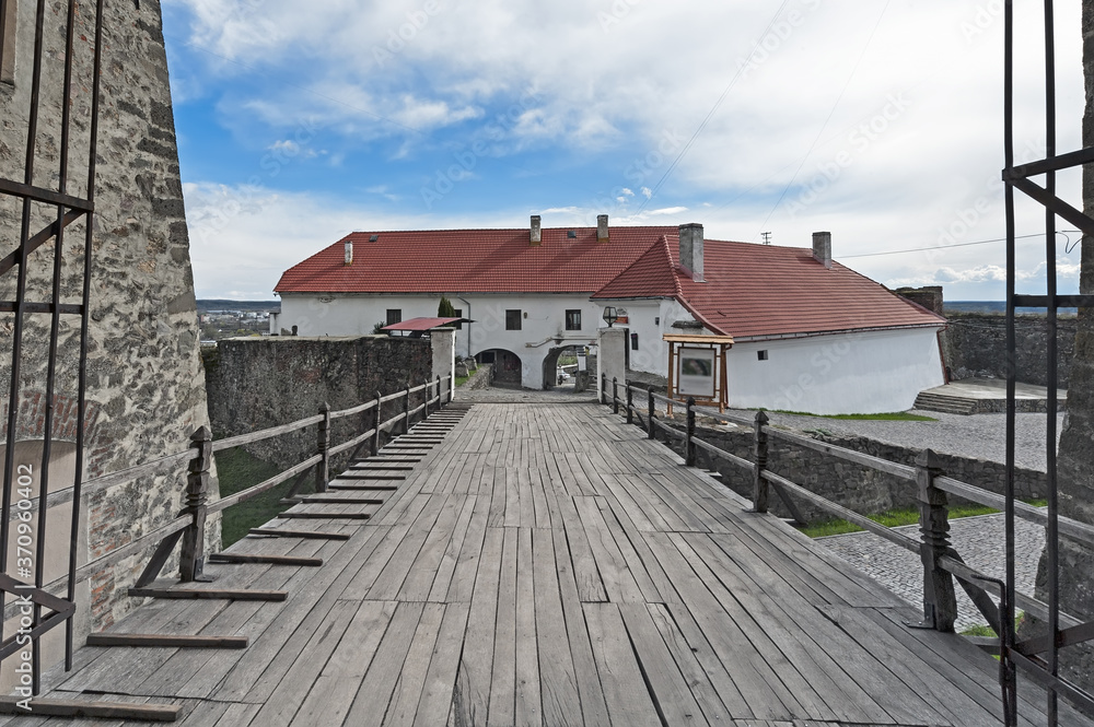 Wooden bridge over a moat of castle Palanok, Mukachevo, Ukraine Wooden bridge over a moat of castle Palanok, Mukachevo, Ukraine