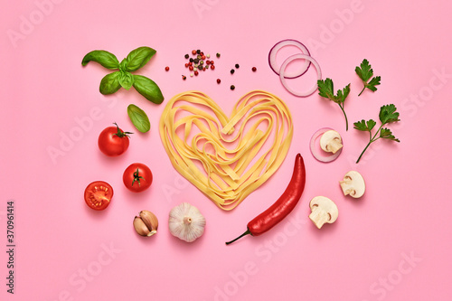 Tomato, basil, spices, champignons, garlic, pasta. Vegan food, creative composition on pink. Fresh basil, tomatoes layout, macaroni heart. Cooking. Italian pasta love concept, top view.