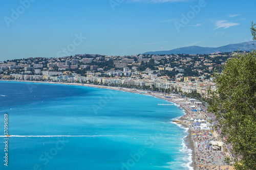 Wonderful panoramic view of Nice with colorful historical houses, seacoast and sea from Cimiez hill. Nice - luxury resort of Cote d'Azur, France. © dbrnjhrj